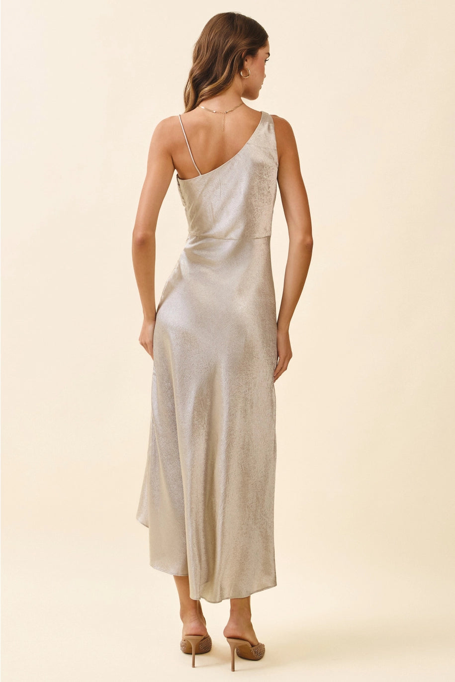 Woman wearing a one-shoulder dress on a beige background