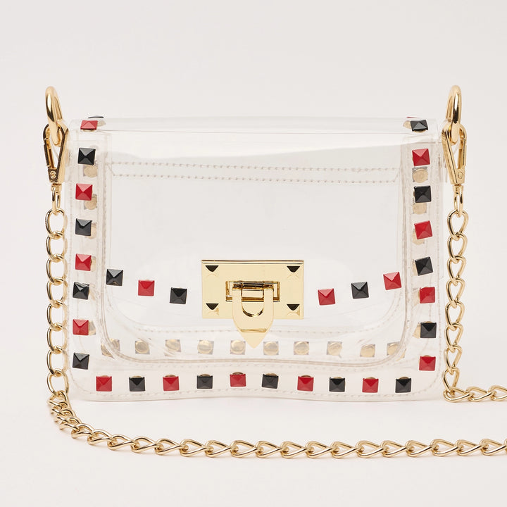 transparent handbag with red and black studded details and a gold chain strap 