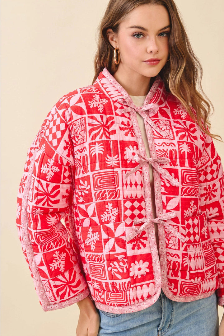 Woman wearing a red and white patterned jacket on a beige background