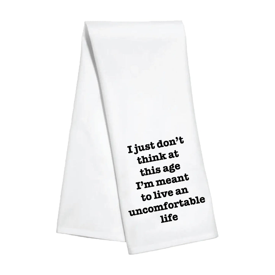 White towel with black text "i just dont think at this age im meant to live and uncomfortable life