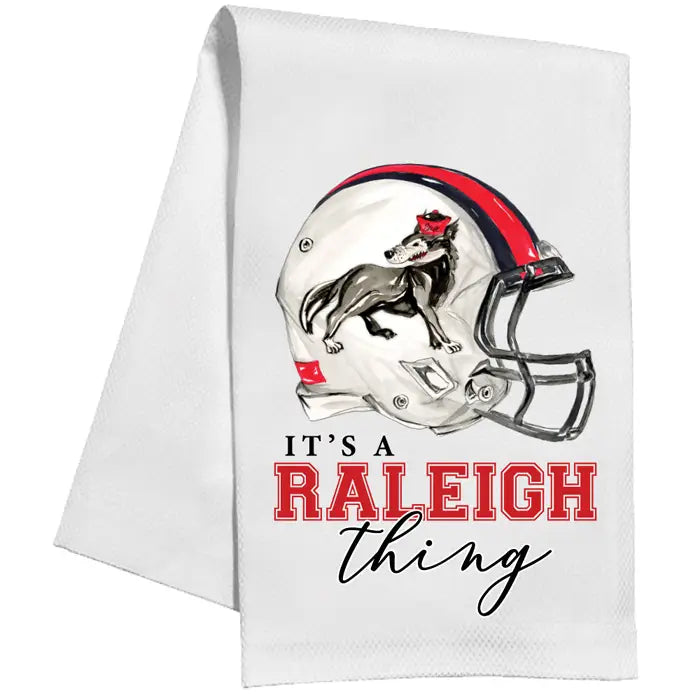 White towel with football helmet and dog graphic, featuring text 'It's a Raleigh thing'.