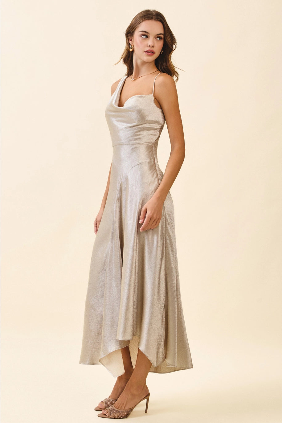 Woman wearing a silver dress on a beige background