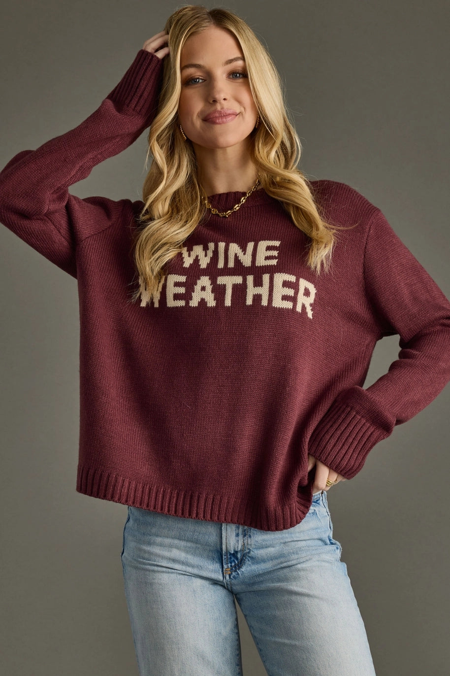 burgundy long sleeve sweater with wine weather text 