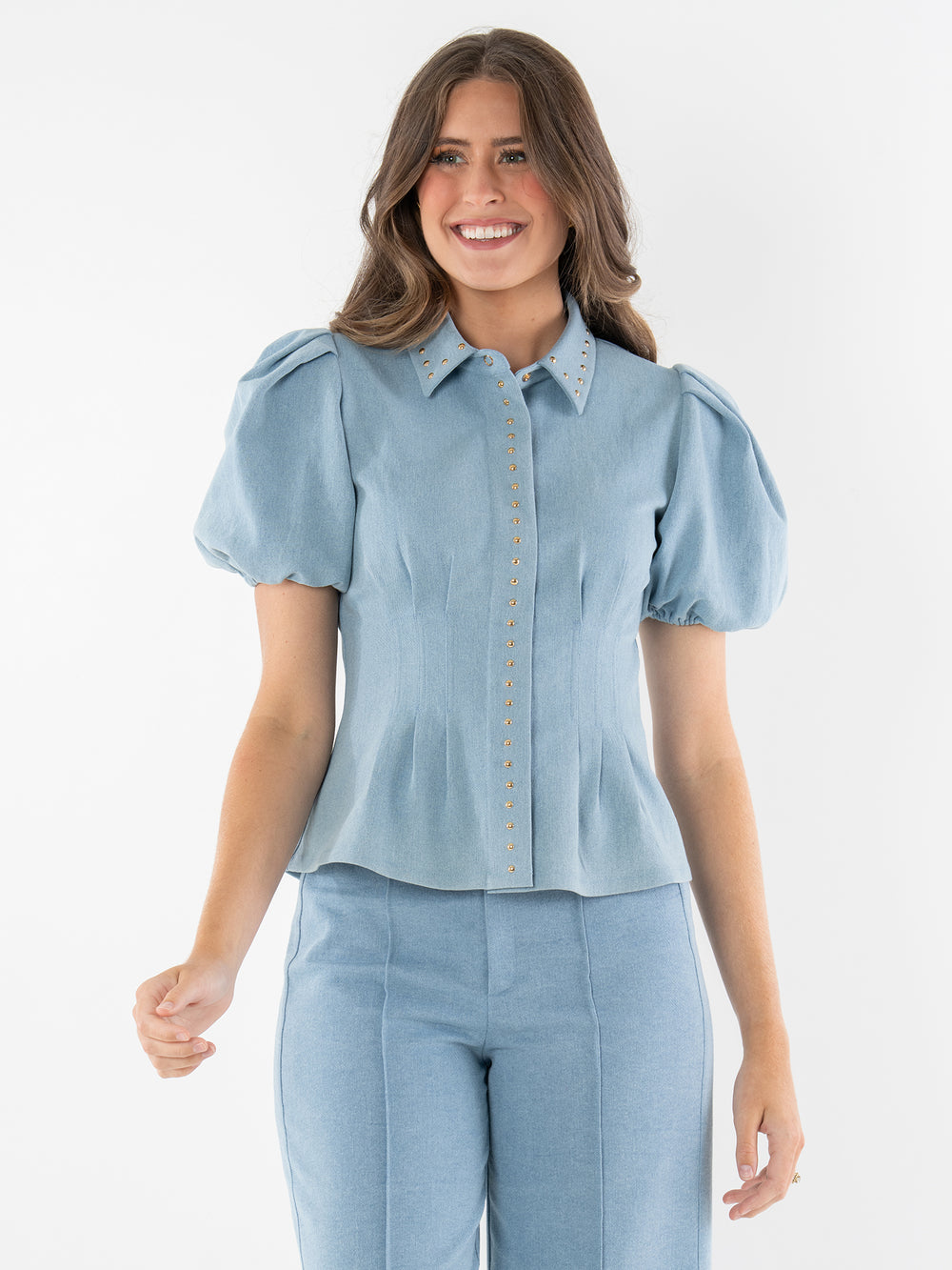 light blue denim top with gold grommet accents and short puff sleeves 