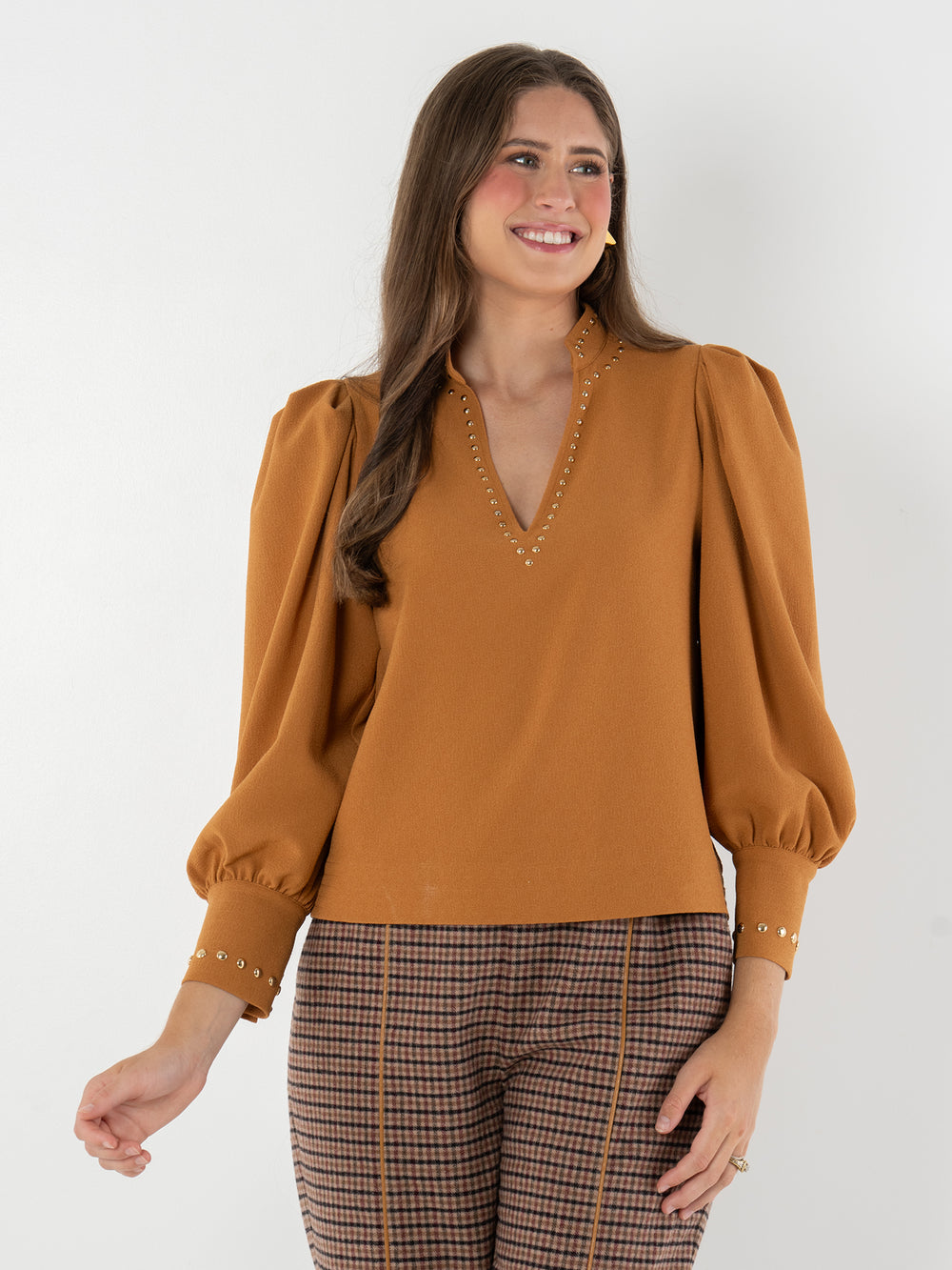 camel long sleeve blouse with deep v neck and gold gromet details
