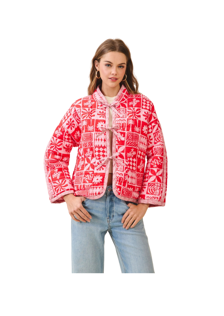 Woman wearing a red patterned jacket on a white background