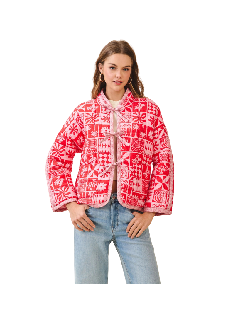 Woman wearing a red patterned jacket on a white background