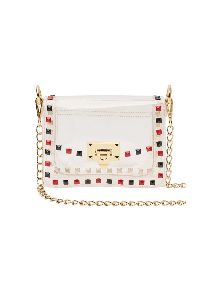 transparent handbag with red and black studded details and a gold 