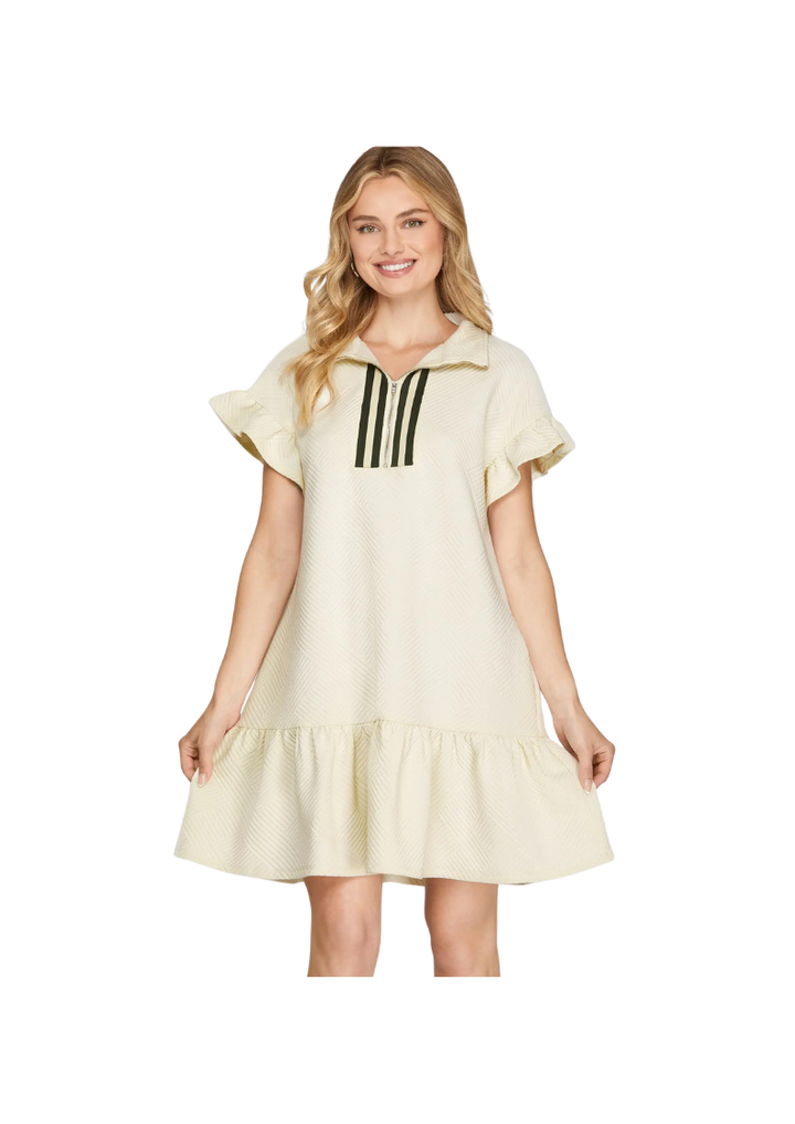 cream mini dress with ruffled hem and short sleeves. 3/4" zip and collar