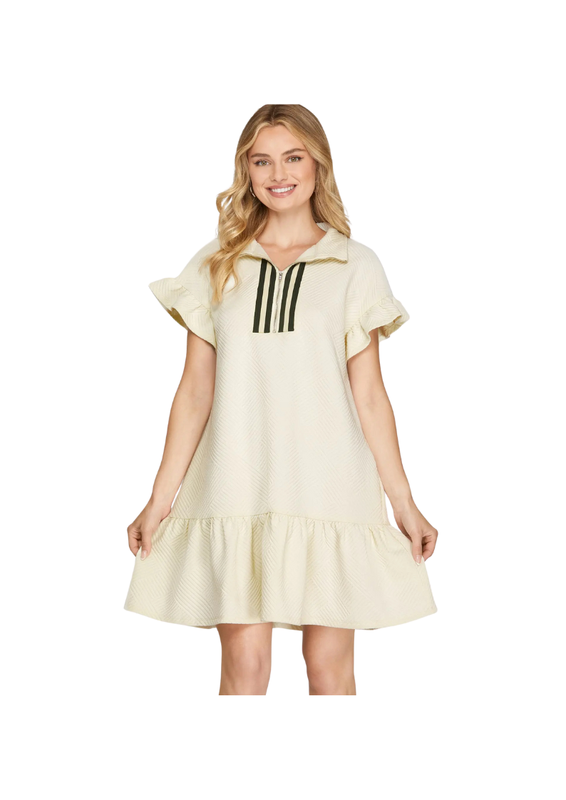 cream mini dress with ruffled hem and short sleeves. 3/4" zip and collar