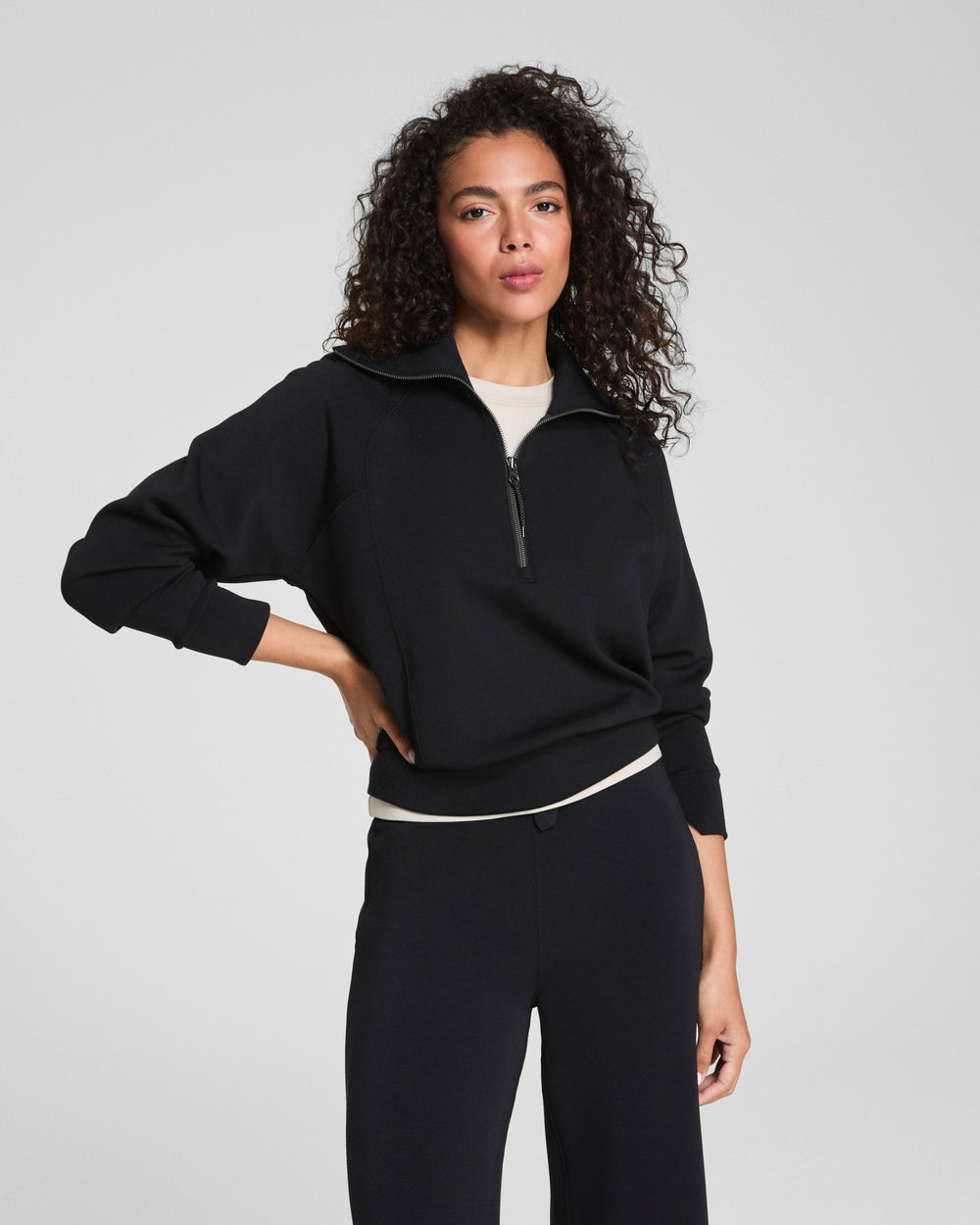 black athleisure long sleeve top with half zip closure front